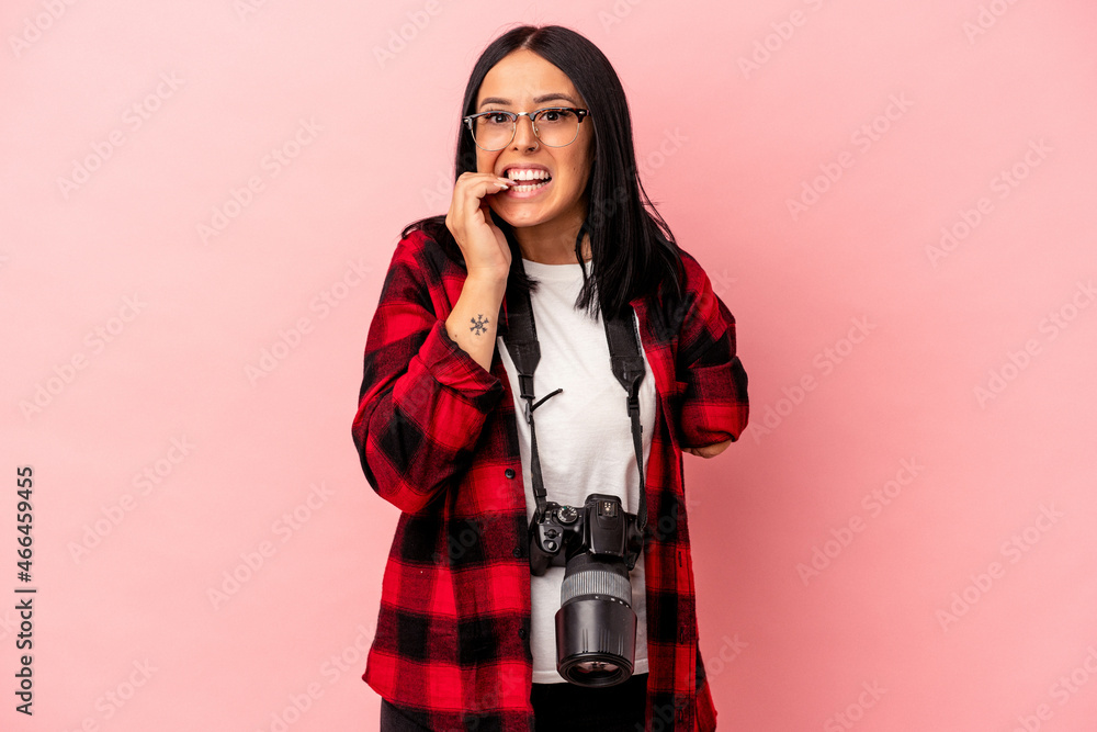 Young caucasian photography woman with one arm isolated on pink background biting fingernails, nervous and very anxious. Young caucasian photography woman with one arm isolated on pink background biting fingernails, nervous and very anxious.