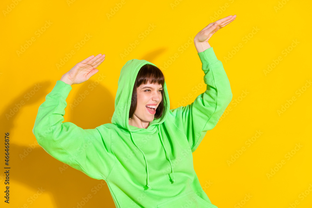 Portrait of attractive cheerful girl dancing moving having fun free time isolated over bright yellow color background Portrait of attractive cheerful girl dancing moving having fun free time isolated over bright yellow color background