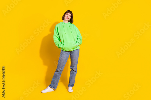 Full length body size view of pretty confident cheerful girl posing wearing cozy clothes isolated over bright yellow color background