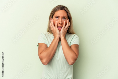 Young caucasian woman isolated on green background whining and crying disconsolately. © Asier