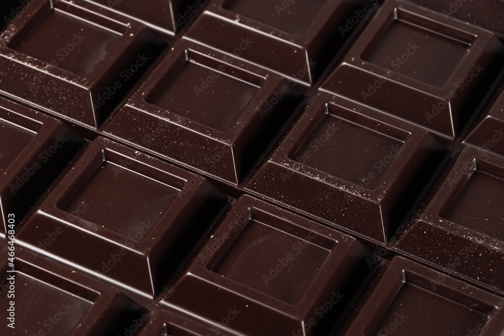 Fototapeta premium Close up a chocolate bar background. Chocolate bar cubes macro