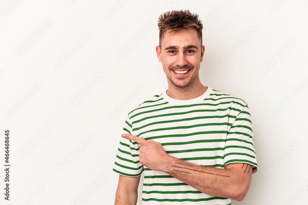 Young caucasian man isolated on white background smiling and pointing aside, showing something at blank space. Young caucasian man isolated on white background smiling and pointing aside, showing something at blank space.