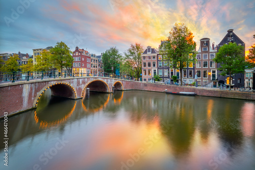 Fototapeta Naklejka Na Ścianę i Meble -  Sunrise colors in Amsterdam. Panoramic views of the famous old houses, the bridge and the canal in the downtown. Amsterdam, Holland, Netherlands, Europe.