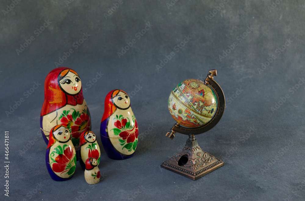 family of mamushkas, russian dolls in front of the planet earth
