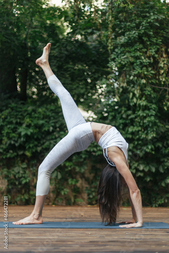 woman in white clothes doing yoga exercise