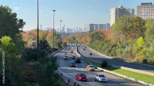 Don Valley Parkway traffic flowing with cars, trucks, motorcycles during Fall morning commute; 4K photo