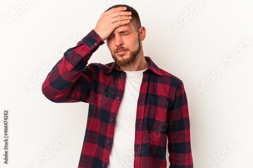 Young caucasian man with diastema isolated on white background having a head ache, touching front of the face.