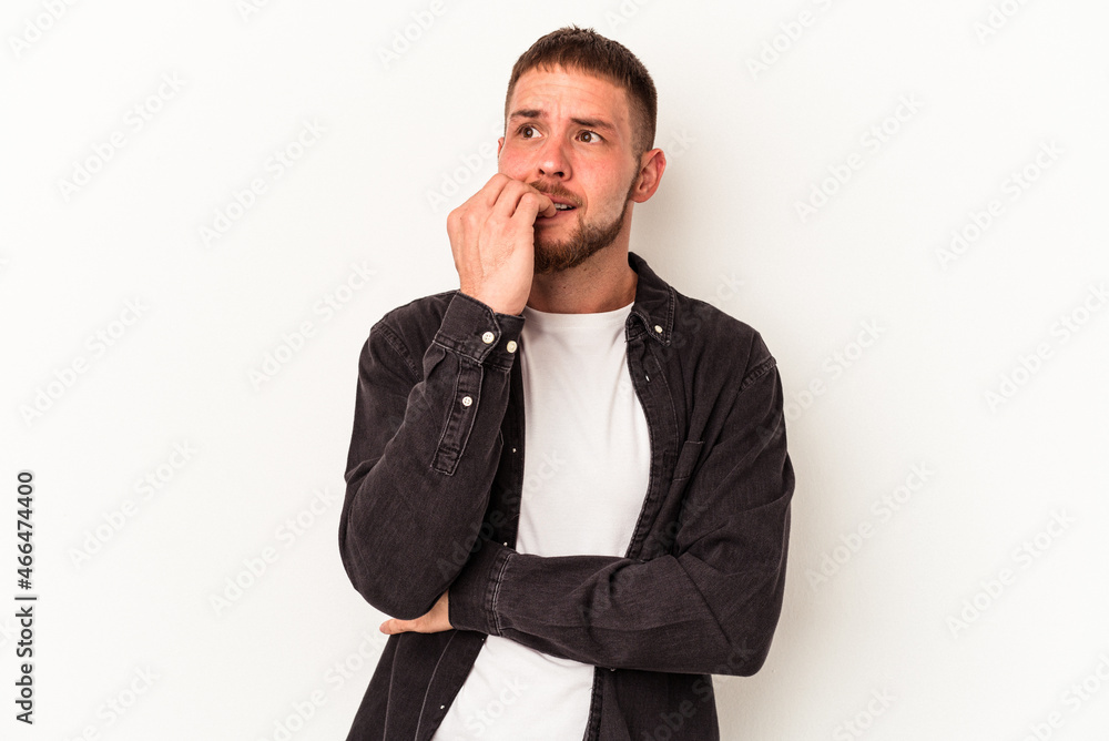 Young caucasian man with diastema isolated on white background biting fingernails, nervous and very anxious. Young caucasian man with diastema isolated on white background biting fingernails, nervous and very anxious.