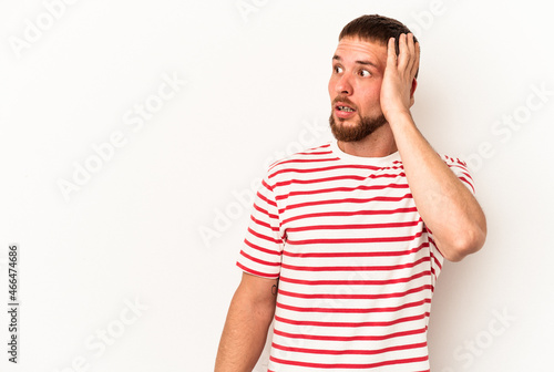 Young caucasian man with diastema isolated on white background being shocked, she has remembered important meeting.