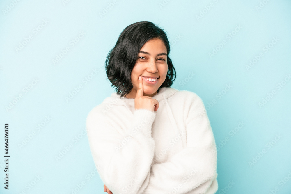 Young latin woman isolated on blue background smiling happy and confident, touching chin with hand. Young latin woman isolated on blue background smiling happy and confident, touching chin with hand.