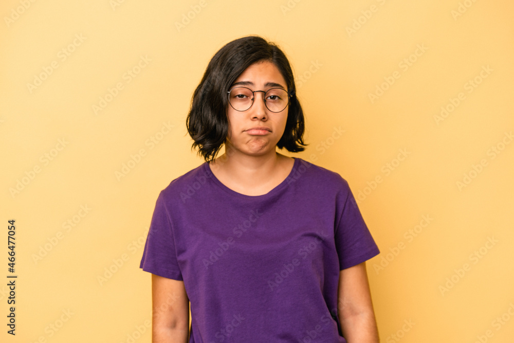 Obraz premium Young latin woman isolated on yellow background sad, serious face, feeling miserable and displeased.