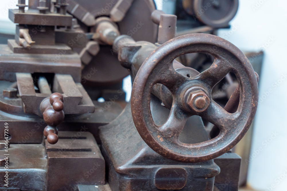 Close-up and selective focus to the circular lever of an old industrial lathe. Close-up and selective focus to the circular lever of an old industrial lathe.