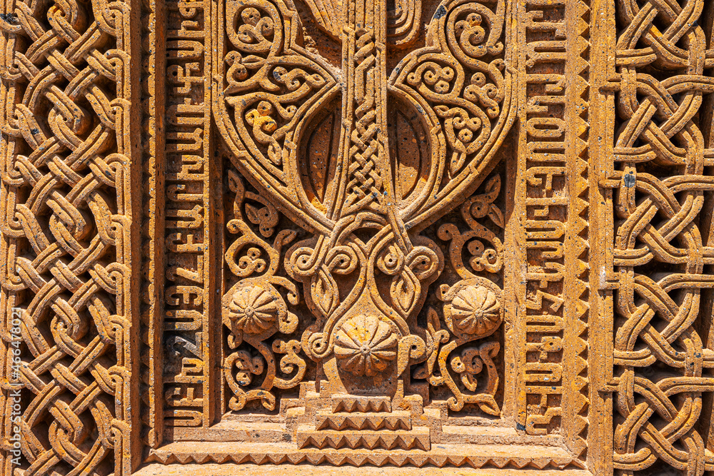 Ancient traditional carved khachkar or cross-stone near Geghard Cathedral, close-up view. Armenian heritage and Art