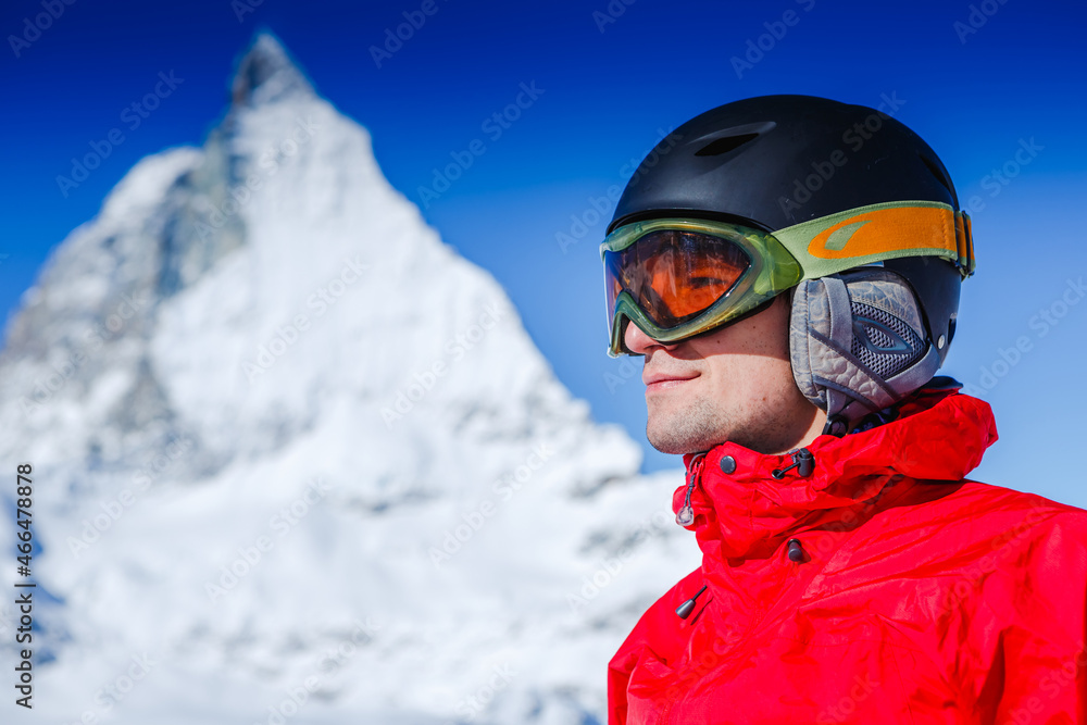 Happy man snowboarder posing with mountain landscape Happy man snowboarder posing with mountain landscape
