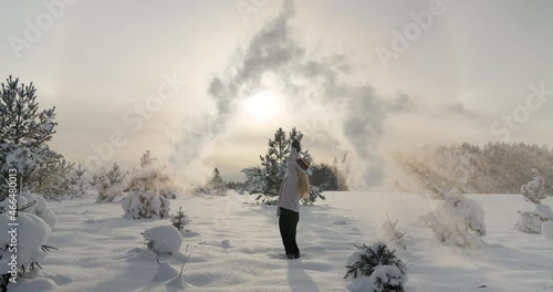 Boiling water challenge woman throw hot water in freezing cold winter air