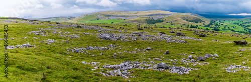 A panorama view showing glacial erratics deposited on the limestone pavement on the southern slopes of Ingleborough, Yorkshire, UK in summertime photo