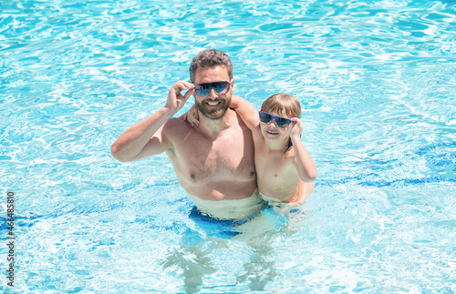 happy family of dad and child having fun in summer swimming pool, happiness