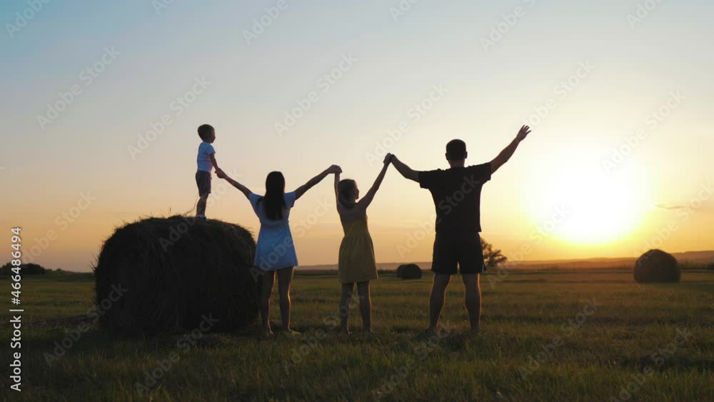 Happy family, parents and childrens silhouettes playing on park. Silhouette family at sunset. Teamwork child and parents run fun in the park. Friendly family and teamwork kid dream concept. Happy family, parents and childrens silhouettes playing on park. Silhouette family at sunset. Teamwork child and parents run fun in the park. Friendly family and teamwork kid dream concept.