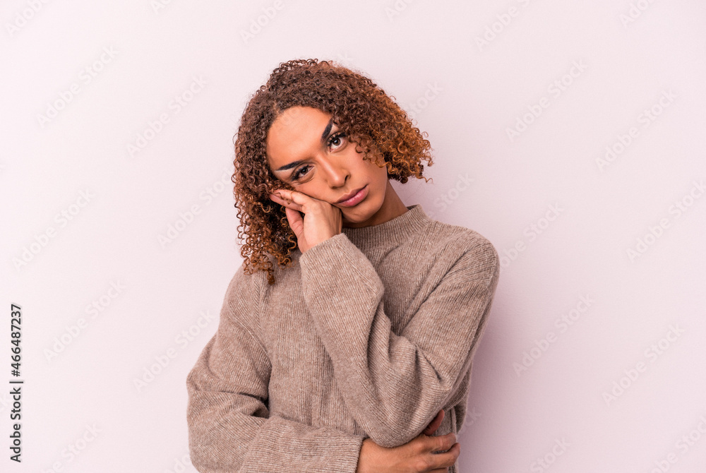 Young latin transsexual woman isolated on pink background tired of a repetitive task. Young latin transsexual woman isolated on pink background tired of a repetitive task.