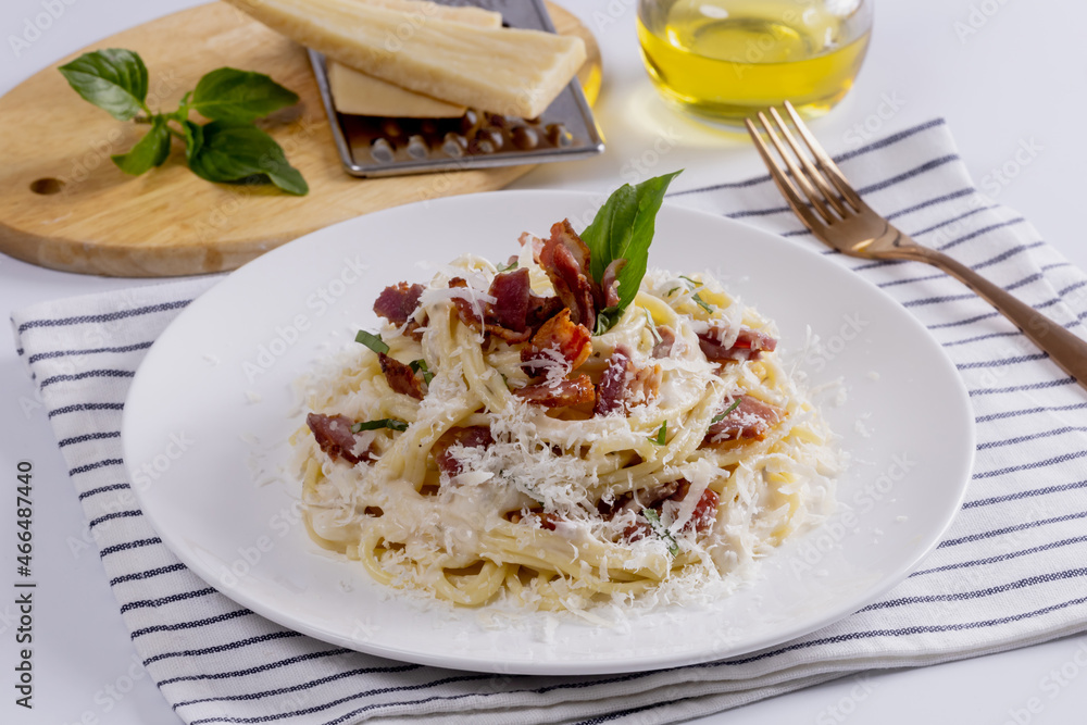 Pasta Carbonara. Spaghetti with bacon, parsel and parmesan cheese. Pasta Carbonara on white plate with parmesan. Italian food. Pasta Carbonara. Spaghetti with bacon, parsel and parmesan cheese. Pasta Carbonara on white plate with parmesan. Italian food.