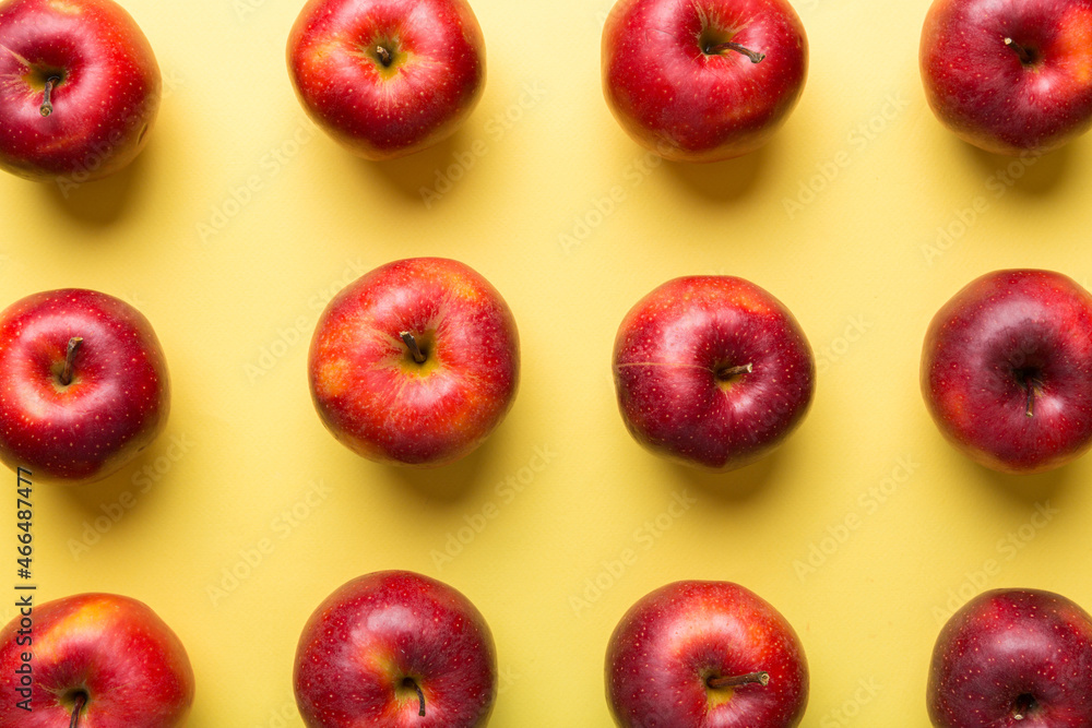 Many red apples on colored background, top view. Autumn pattern with fresh apple above view