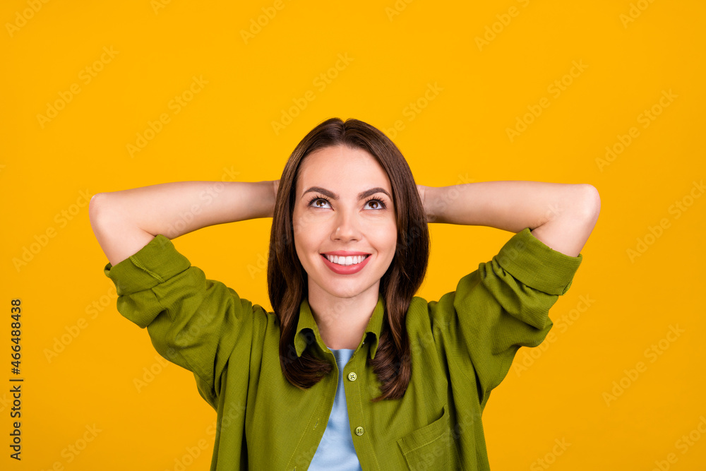 Photo of sweet millennial brown hairdo lady hands head look up rest wear green shirt isolated on yellow color background Photo of sweet millennial brown hairdo lady hands head look up rest wear green shirt isolated on yellow color background
