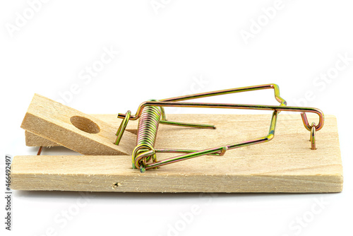 Macro photo of a spring loaded mousetrap, isolated on a white background, side view.