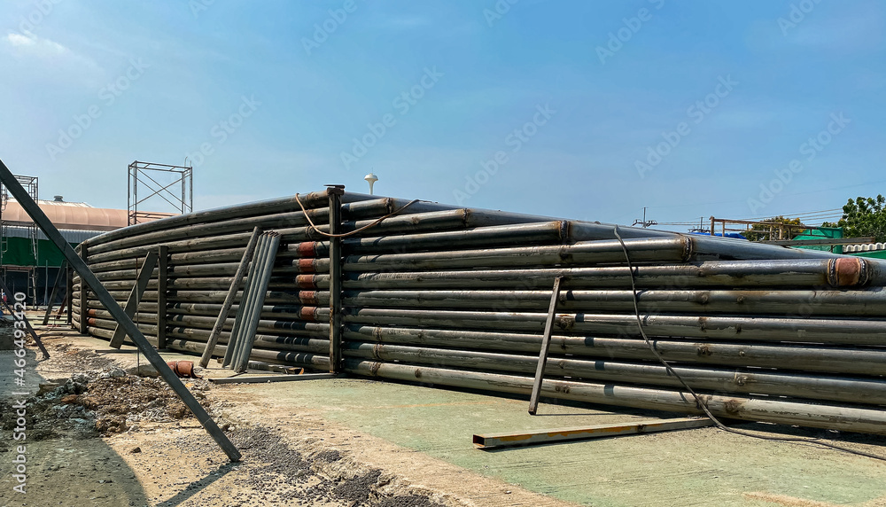 Large steel pipes stacked layers high. For building construction in the outdoor. Large steel pipes stacked layers high. For building construction in the outdoor.
