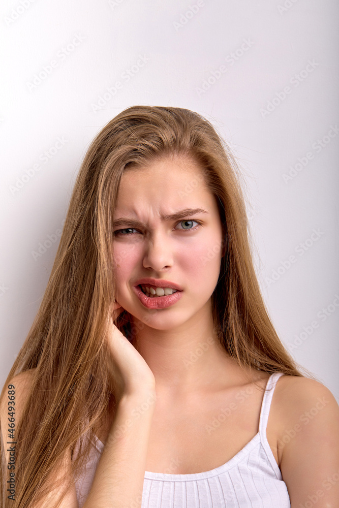 Puzzled perplexed female is dissatisfied with something, looking curious isolated on white background, misunderstanding facial expression, wearing casual white undershirt. portrait, copy space Puzzled perplexed female is dissatisfied with something, looking curious isolated on white background, misunderstanding facial expression, wearing casual white undershirt. portrait, copy space