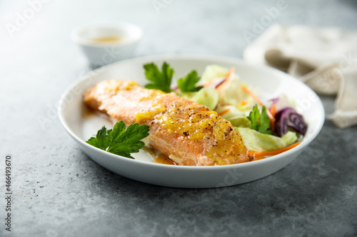 Baked salmon with orange sauce and salad