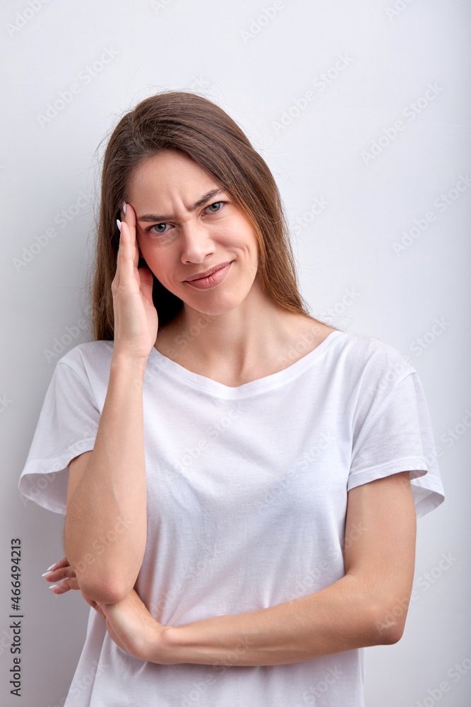 Portrait of young caucasian woman wondering, headache with anxious, not happy, beautiful woman with unconfidence, beautiful on white studio background. Pretty female casually dressed look at camera Portrait of young caucasian woman wondering, headache with anxious, not happy, beautiful woman with unconfidence, beautiful on white studio background. Pretty female casually dressed look at camera