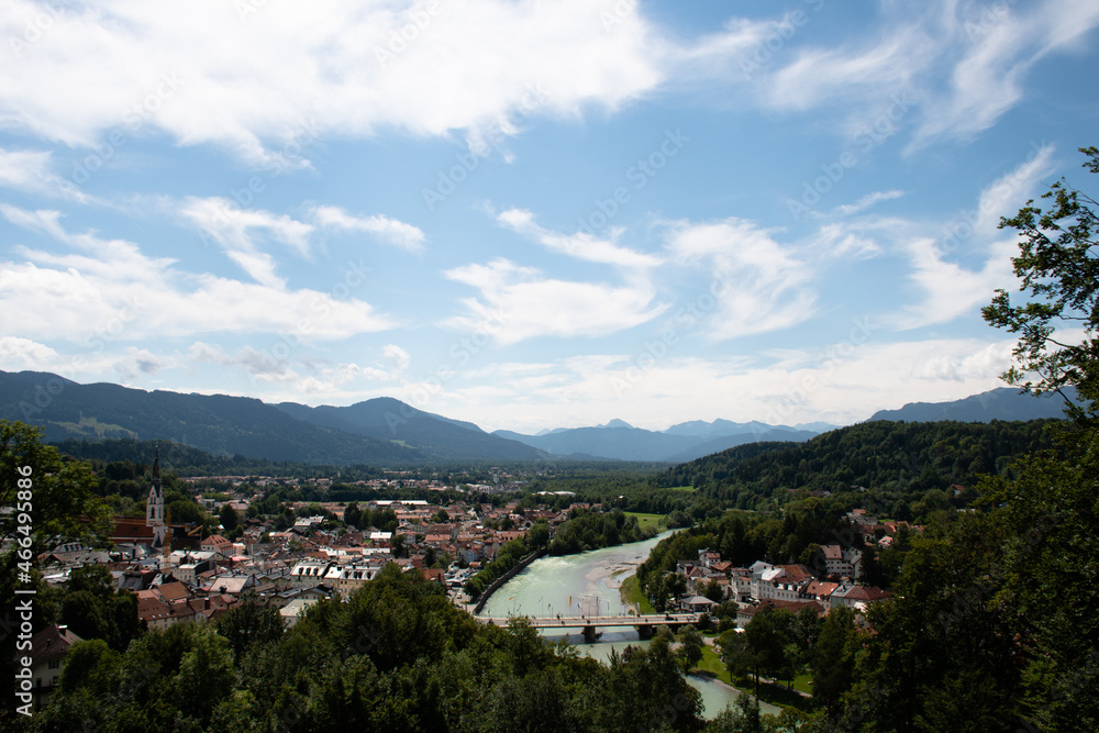 View of the town of Bad Tölz in Upper Bavaria in Germany on a summer day, with the Isar river flowing through the town and the mountains of the Alps in the distance