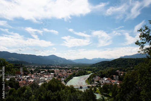 View of the town of Bad Tölz in Upper Bavaria in Germany on a summer day, with the Isar river flowing through the town and the mountains of the Alps in the distance