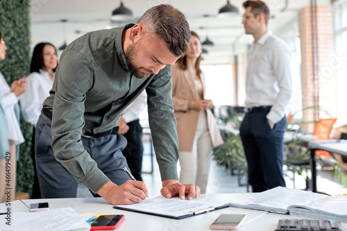 Canvas Print Young confident business man signing financial contract, put write signature on