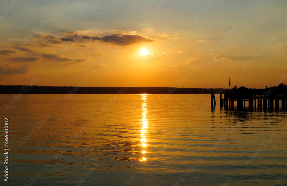a pier on lake Ammersee at sunset in Herrsching on a warm August night (Bavaria, Germany)