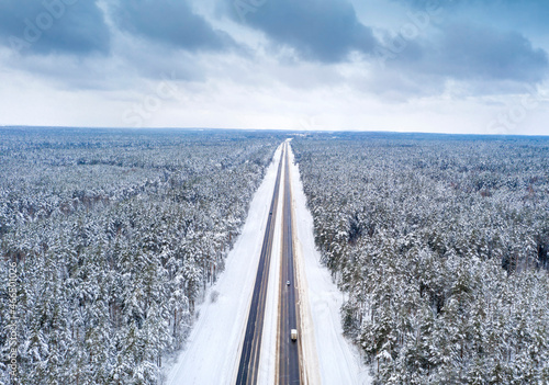 Aerial bird-eye view on freeway road in the winter field