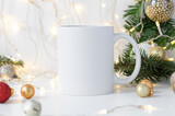 White ceramic tea mug with Christmas decorations and empty space for your design. Mockup for xmas promotional imprint content. WInter 11oz cup
