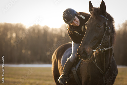Slika na platnu Female horse rider riding outdoors on her lovely horse