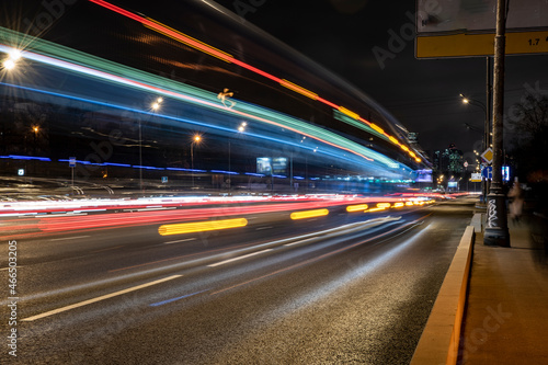 night landscape with a freeway and fast moving cars leaving a solid trail 