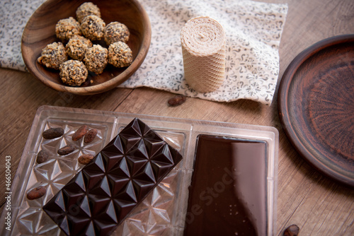 Chocolate on wooden table. Close-up. Copy space. 
