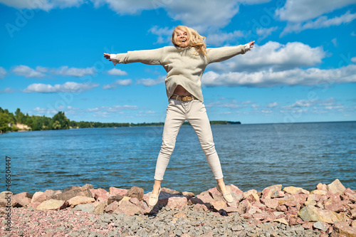 Energetic woman while jumping on seashore
