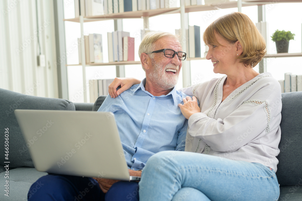 Happy Caucasian senior couple using laptop at home Happy Caucasian senior couple using laptop at home