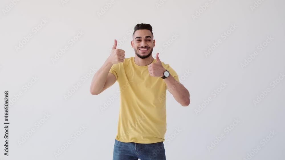 Man giving thumbs up gesture with both hands over white background Man giving thumbs up gesture with both hands over white background