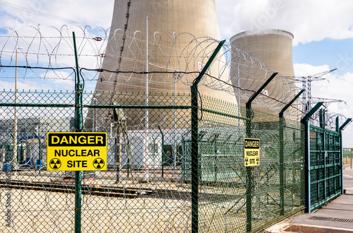 Security fence with danger warning signs of a nuclear power station