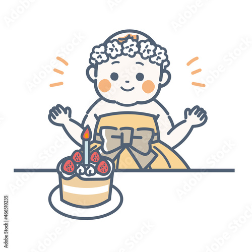 誕生日をお祝いされているベビードレス姿の赤ちゃん