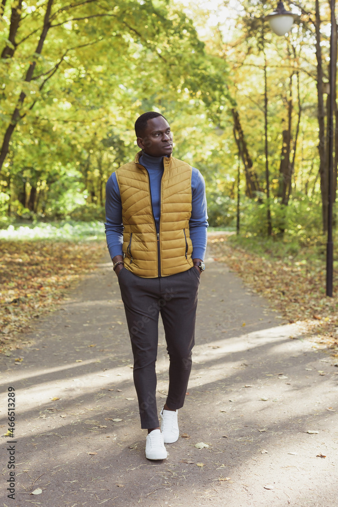 African american male student walking in the park African american male student walking in the park