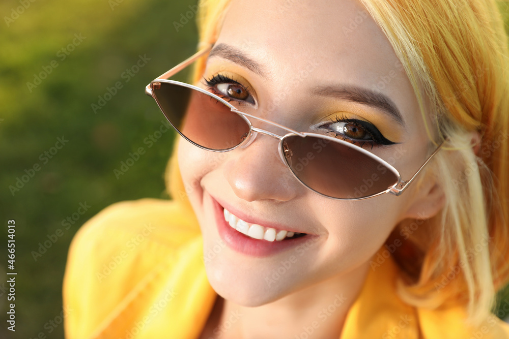 Beautiful young woman with bright dyed hair on blurred green background, closeup Beautiful young woman with bright dyed hair on blurred green background, closeup