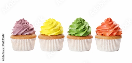 Different delicious colorful cupcakes on white background