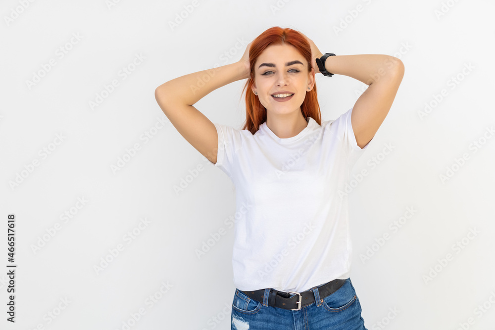 Beautiful modern redhead woman playing with ginger hair on white background Beautiful modern redhead woman playing with ginger hair on white background