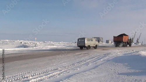 Chukotka, Russia. - 13 April 2013: Snow-removing machine cleans road in Anadyr city on far north. Cold snow town on edge of earth. photo